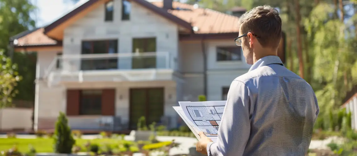 Property valuer assessing a house exterior before valuation report
